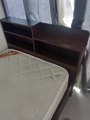 Single bed with mattress and storage shelves