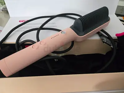 Lightly used pink heated hair straightening brush