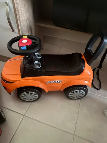 Orange ride-on push car for toddlers, good condition