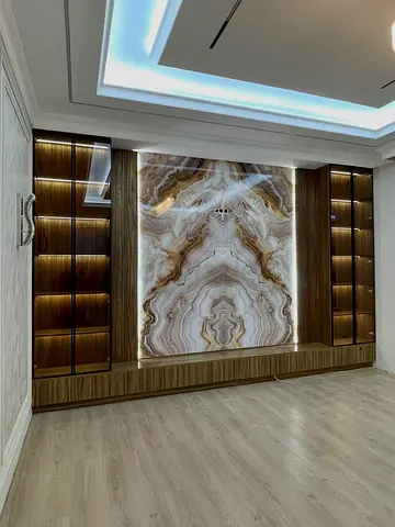 Wall-mounted entertainment unit with backlit onyx feature panel