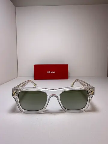 Prada clear frame sunglasses with gold accents