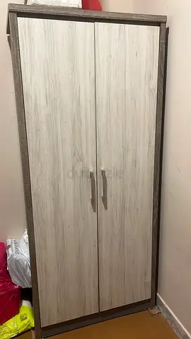 Two-door freestanding wardrobe in light wood finish - good condition ( total two cupboards)
