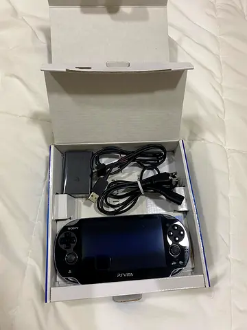 PlayStation Vita (PS Vita) with charger and USB cable - Good working condition