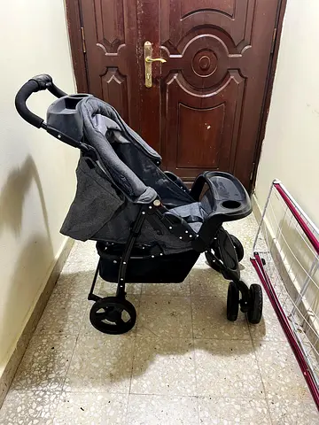 Lightweight grey baby stroller with snack tray and storage basket