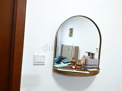 Wall-mounted arched mirror with small shelf - gold frame