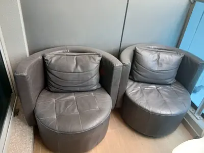 Brown leather swivel lounge chair with ottoman