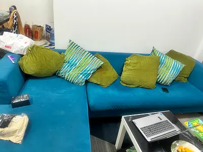 Blue L-shaped Fabric Sofa with Green Cushions - Good Condition..move out sale..need to go by 26 june