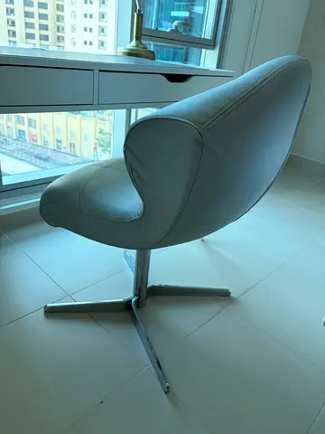 Modern grey swivel lounge chair with chrome base