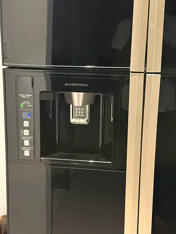 Black double-door refrigerator with built-in water/ice dispenser