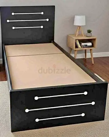 Single black wooden bed frame with decorative chrome inlays