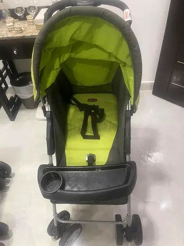 Lightweight green baby stroller with canopy and cup holder