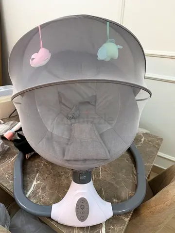 Lightly used grey baby rocker/swing with canopy and toys