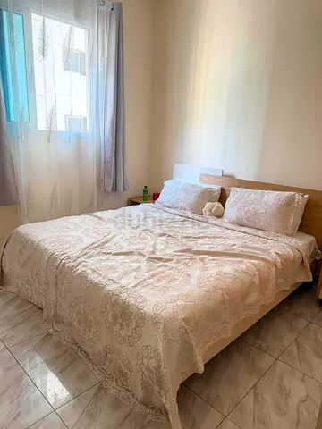 Queen size bed frame with mattress and bedding - light wood