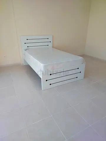 Double white bed frame with headboard and mattress