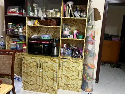 Large multi-compartment kitchen storage cabinet with shelves and cupboards