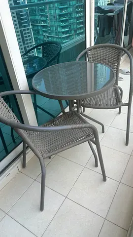 Small outdoor bistro set - glass top table with two woven chairs