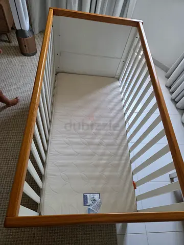 Solid wood baby crib with mattress - gently used and clean. Double sided for different ages.