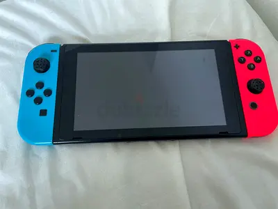 Nintendo Switch console with Neon Blue/Red/purple/orange Joy‑Cons - normal condition with games