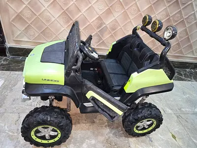 Two-seater electric ride-on off-road buggy for kids - good condition