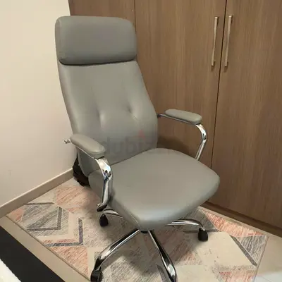 Grey ergonomic high-back office chair with headrest