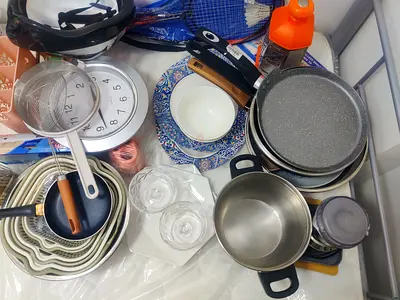 Lot of kitchen cookware and utensils - pans, strainers, bowls, plates