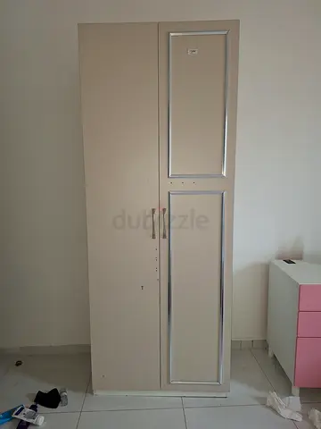 Two-door beige wardrobe with silver trim — good condition