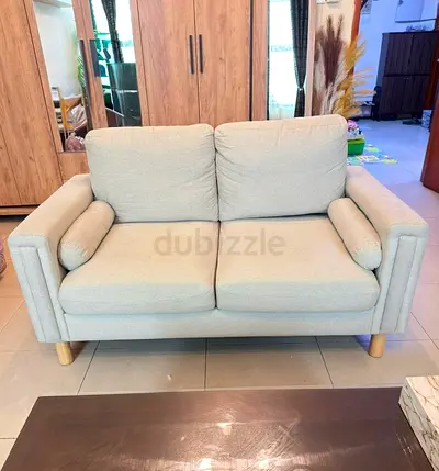 Beige color 2-seater fabric sofa in good condition