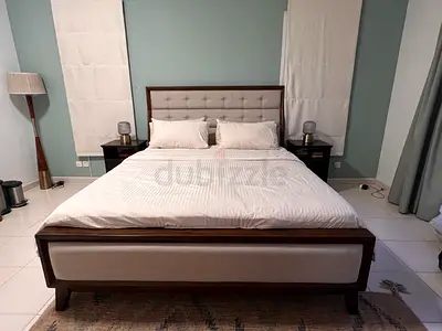 King size  wooden bed frame with upholstered headboard and footboard with bedside tables