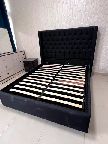 Queen-size tufted black fabric bed frame with headboard
