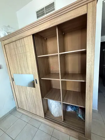 wood storage cabinet with open cubbies and sliding doors
