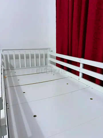 White wooden bunk bed frame with mattress — good condition