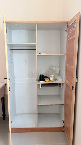Light wooden wardrobe / armoire with shelves and hanging rail — used