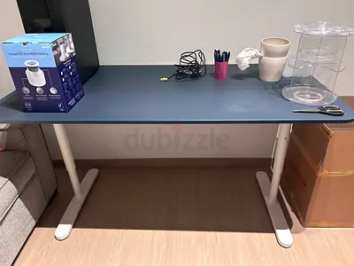 Height-adjustable standing desk with blue top