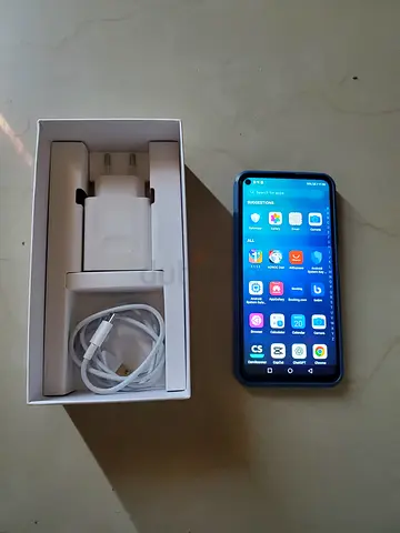 Huawei smartphone with charger and USB cable - good condition