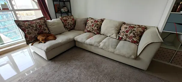 Biege L-shape sofa with cushions