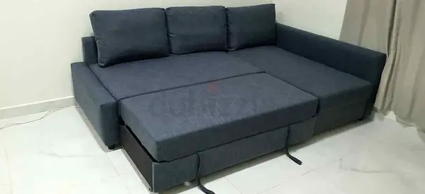 Dark grey fabric L-shaped sofa bed, convertible with storage
