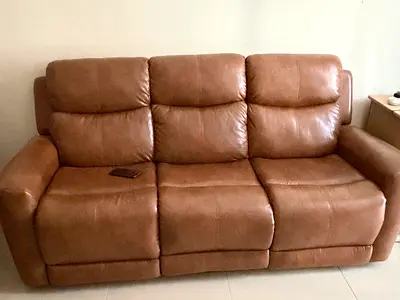 Gently used 3-seater brown leather reclining sofa