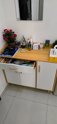 Compact wooden storage cabinet with drawers and shelves