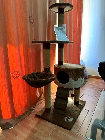 Used multi-level cat tree with scratching posts and condo