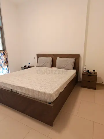 King size wooden bed frame with storage box with mattress and matching nightstands from Home Centre