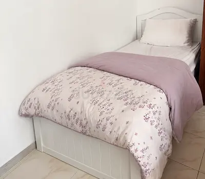 Single white wooden bed frame with mattress and bedding - good condition