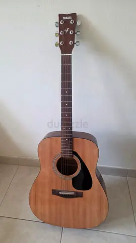 Acoustic guitar with picks and tuner
