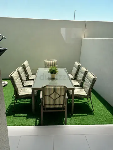 Outdoor 8-Seater Dining Set with Cushioned Chairs and Glass Table