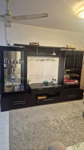 Dark wood entertainment unit with shelving and glass display cabinet