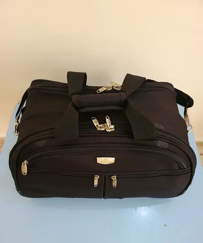 Travel Bag Black soft duffel with shoulder strap and moves on wheels