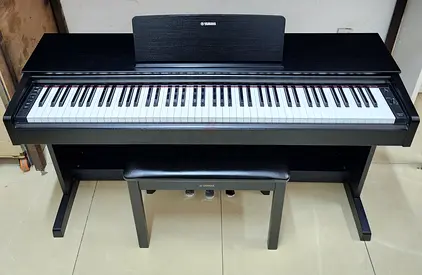 The Yamaha YDP-143B is an 88-key console digital piano (finished in Black Walnut) designed