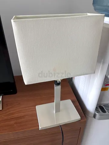 Modern rectangular table lamp with fabric shade and metal base.