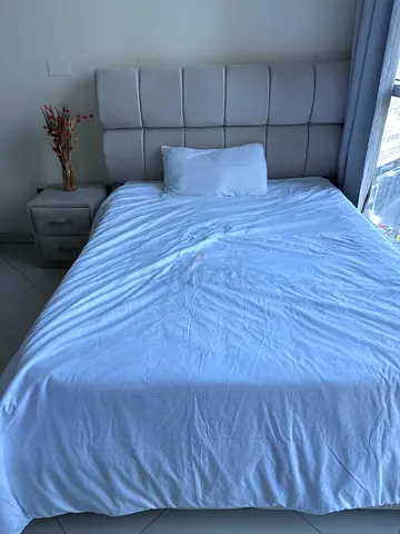 Queen size upholstered bed with padded headboard