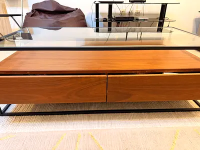 Modern glass-top coffee table with wooden drawers