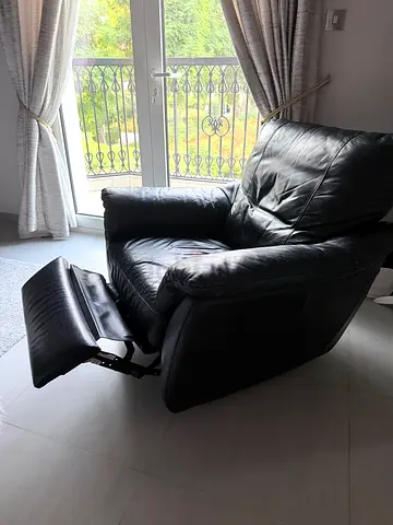 Black leather recliner armchair with footrest - good condition